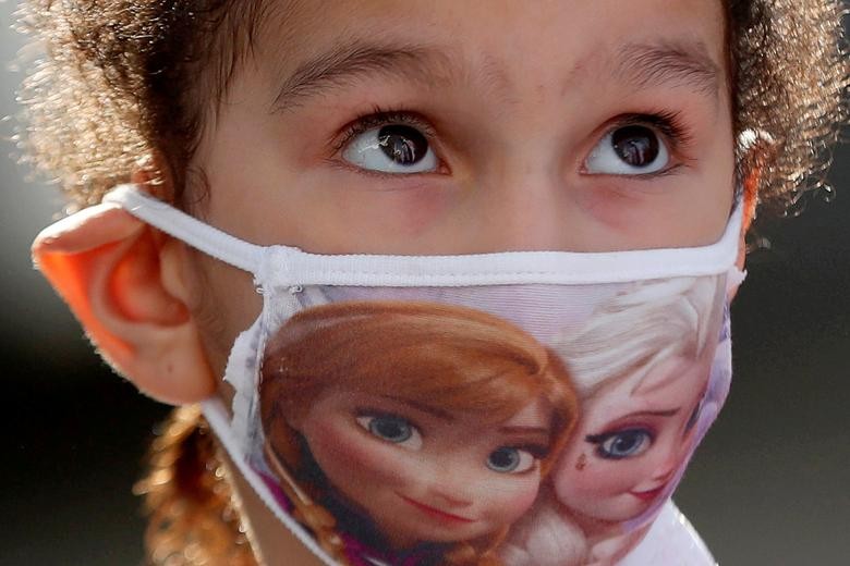 A Palestinian student wears a protective face mask at a United Nations-run school as schools gradually reopen amid the coronavirus outbreak, in Ramallah in the Israeli-occupied West Bank. REUTERS/Mohamad Torokman    